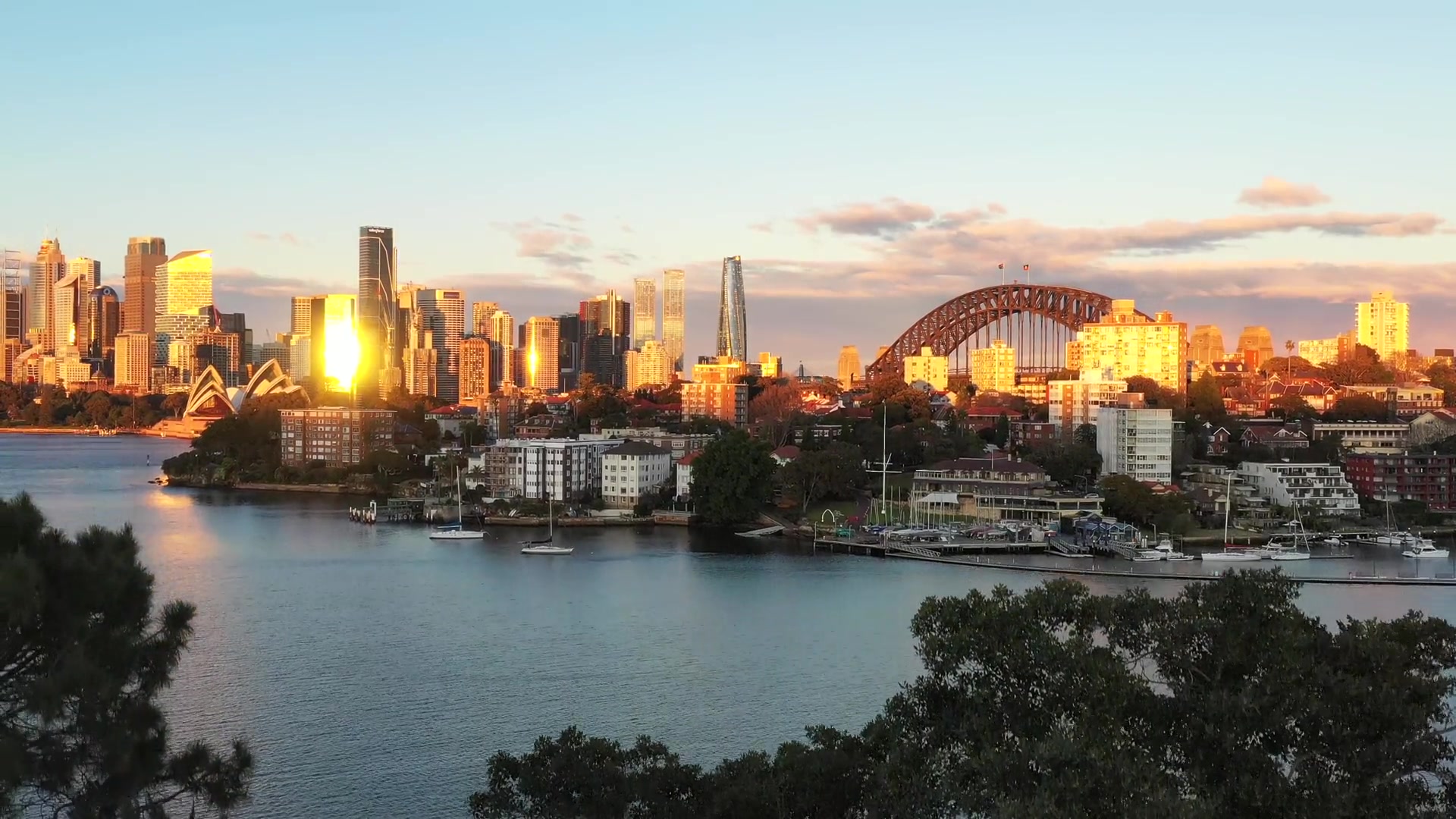 Sydney Harbour with sun shining on the buildings